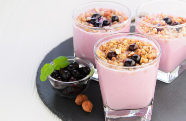 Berry yogurt with oat flakes in glasses