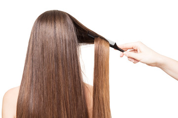 Barber combs Hand luxurious long hair isolated on white.