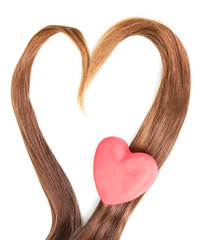 Frame made  strands of hair in  shape  heart isolated.