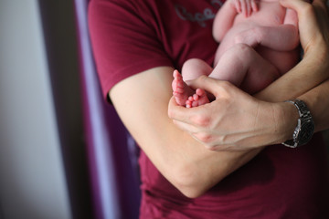 newborn baby feet in parents hands