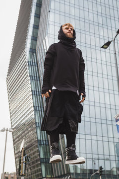 Stylish bearded man levitating in the street
