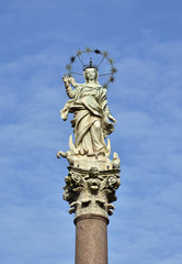 Fototapeta na wymiar Mary of the Stars. Beautiful statue of Virgin Mary crush dragon and crescent in the historic center of Lucca, made by the artist Giovanni Lazzoni in 1687