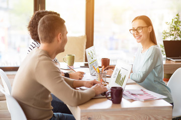 Cheerful colleagues working on the table 