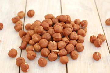 Hazelnuts on the wooden background