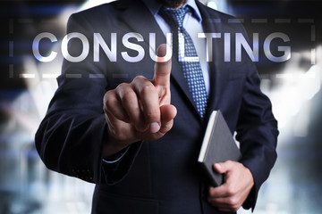 Businessman is pressing on the virtual screen and selecting Consulting.