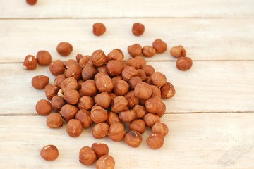 Hazelnuts on the wooden background