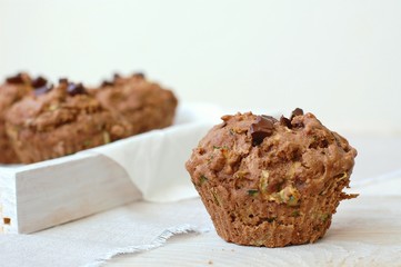 Chocolate muffins on the white and pink background
