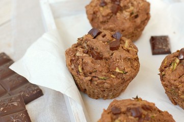 Chocolate muffins on the white and pink background