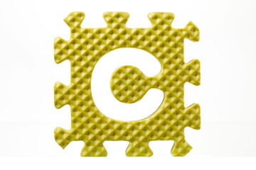 rubber alphabet puzzle with a detached letter c