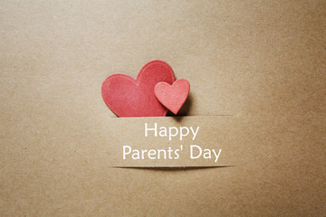 Parents day message with handmade red small hearts
