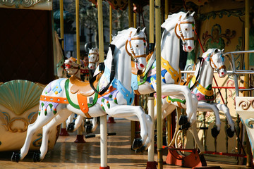 Fototapeta na wymiar detail of white horses and carriage in a carousel, roundabout or merry-go-round retro style 