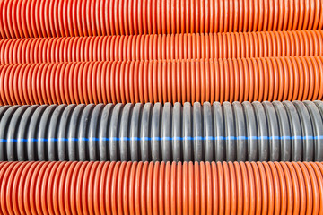 Construction orange and black plastic pipes