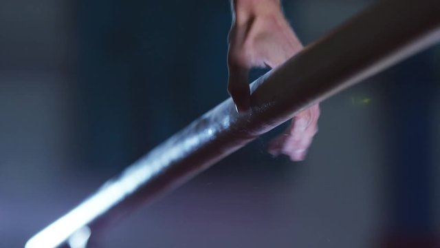  Professional male gymnast training on parallel bars at the gym