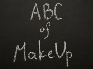 ABC of make up chulk title on black desk.