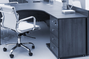 desks and white leather armchairs