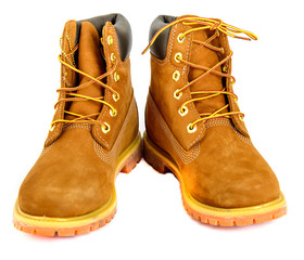Brown lady's boots with shoelace on white background.