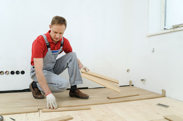 Laying hardwood parquet.