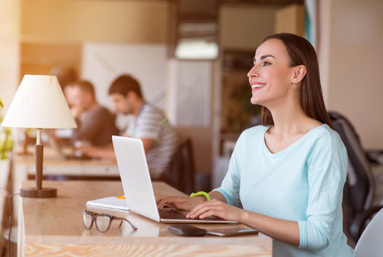 Joyful  woman sitting at the table