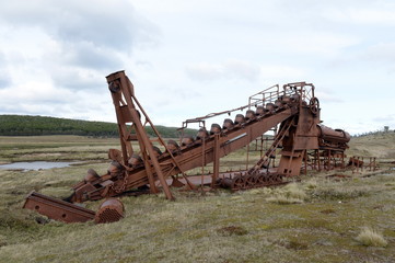 Fototapeta na wymiar Abandoned gold mine at lake Lago Blanco. English mechanical dredge was engaged in gold mining from 1904 to 1910.