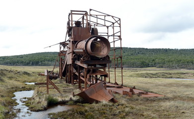 Abandoned gold mine at lake Lago Blanco. English mechanical dredge was engaged in gold mining from 1904 to 1910.