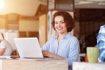 Pleasant  woman using laptop 