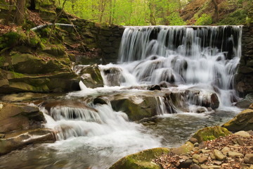 Fototapeta na wymiar Waterfall in middle of forest