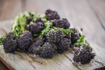 Purple broccoli  on wooden board