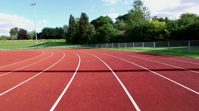  Drone footage of large modern running track, no people. 
