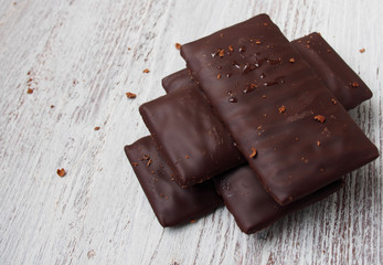 Still life of broken chocolate bar  on wooden table