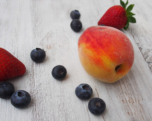 Fresh berries on rustic natural wooden board
