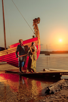 North princess and warrior with sword on the sailing ships backg