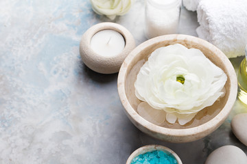 Fototapeta na wymiar Spa and wellness massage setting, white floating ranunculus flowers