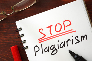 Stop plagiarism sign written in a notepad.