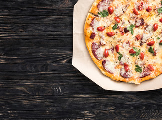 delicious pizza with text space on dark background top view