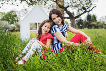 happy mother and little daughter in the garden