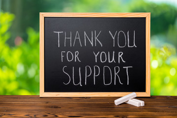 handwriting text thank you for your support is written in chalkb