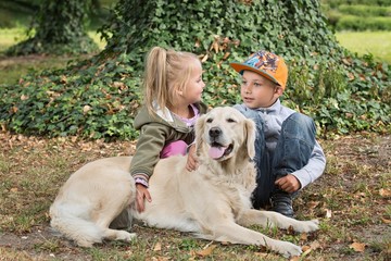 siblings with a golden retriever