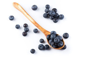 Fresh blueberries in wooden spoon