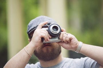 Young stylish photographer with vintage camera