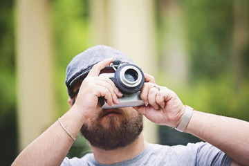 Young stylish photographer with vintage camera