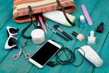 Fototapeta na wymiar summer women set with straw bag, smartphone with headphones