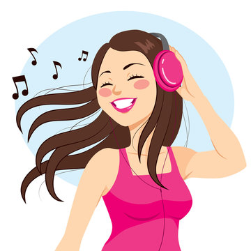 Beautiful young brunette woman listening music with headphones
