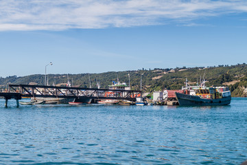 Fototapeta na wymiar DALCAHUE, CHILE - MARCH 21, 2015: Ships in a harbor of Dalcahue, Quinchao island, Chile