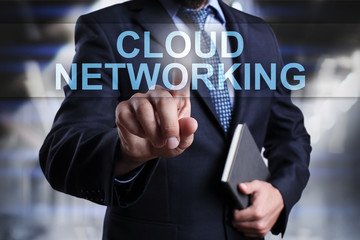 Businessman is pressin on virtual screen and selecting Cloud Networking.