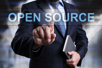 Businessman is pressing on virtual screen and selecting Open source.