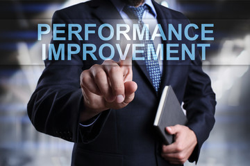 Businessman is pressing on virtual screen and selecting Performance improvement.