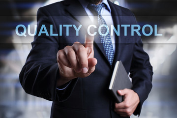 Businessman is pressing button on virtual screen and selecting Qaulity Control.