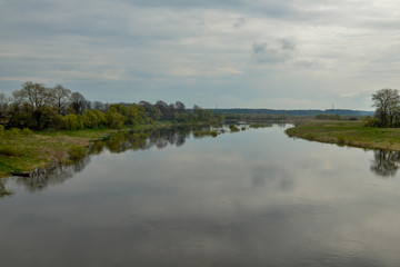 Fototapeta na wymiar wooded banks of flooded Dzisna river in spring Dzisna, Belarus