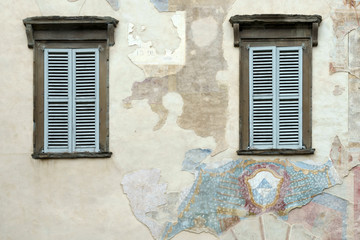Old faded mural on a wall in Citta Alta Bergamo