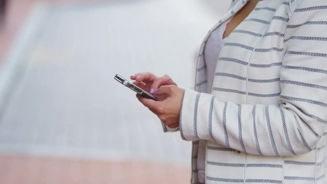  Portrait of beautiful young woman texting on mobile phone outdoors in the cit